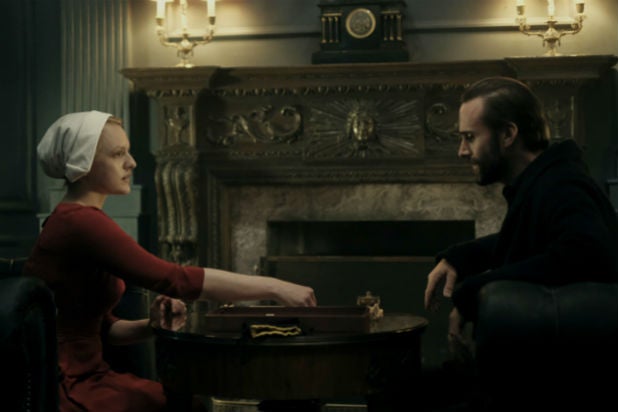 https://www.thewrap.com/wp-content/uploads/2017/04/handmaids-tale-fiennes-and-moss.jpg