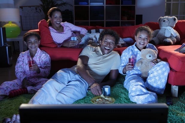 family watching tv together at night