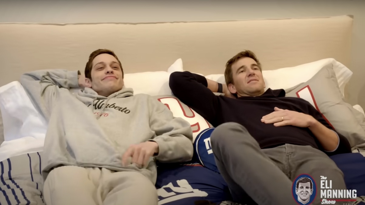 Pete Davidson Freaks Out Eli Manning by Showing Off His Bedroom Shrine… to Eli Manning (Video)